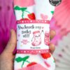 A hand holds a pair of fuzzy socks decorated with strawberries and hearts, wrapped in the "Valentines Day Socks Wrap Printable" that says, "You knock my socks off! Happy Valentine's Day! From Katie," with two cartoon smiling socks.