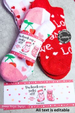 Wrap two cozy pairs of fuzzy socks—one red with white hearts, one pink with cherries—using the Valentines Day Socks Wrap Printable labeled “You knock my socks off!” for a sweet Kinder Bueno Valentines exchange.