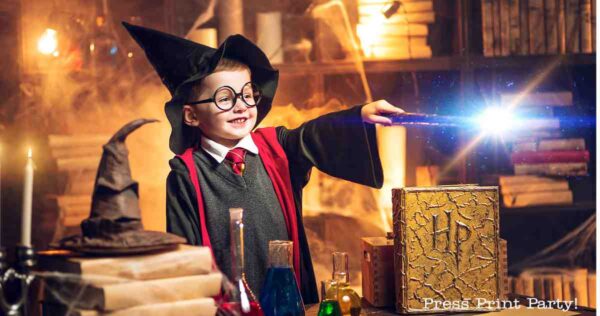 A smiling child dressed as a wizard with glasses and a pointed hat waves a glowing wand in a magical, book-filled room—perfect inspiration for Harry Potter party ideas, with potions bubbling and a large "HP" book on the table.