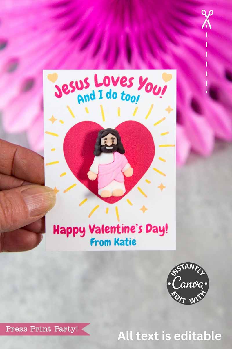 A hand holds the Jesus Loves You Valentine Card, showing a smiling Jesus with open arms among red and yellow hearts, next to adorable panda party favors. The card says, “Jesus Loves You! And I do too! Happy Valentine’s Day! From Katie.”.