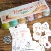 The Printable Resurrection Eggs Set includes an egg carton with labels, colorful eggs, story cards, cut-out images, and a "PDF Instant Download" badge—all displayed on a wooden table.