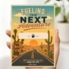 A hand holds the Gas Gift Card Holder Printable - Mountain, featuring a mountain scene and sunset. The card reads “Fueling Your Next Adventure,” includes a fuel pump icon, blank space, and Kate’s note: “Wherever your life takes you, enjoy the ride.”.