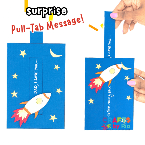 A hand pulls a tab on a blue card decorated with stars and a rocket, revealing a hidden message that says "I LOVE YOU... TO THE MOON & BACK." The card also reads "DAD, I LOVE YOU..." and "CRAFTS by Ria" in the corner.