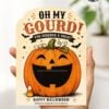 A hand holds one of the “7 Vintage Halloween Gift Card Holders,” showcasing a card with a smiling jack-o’-lantern, bats, candy corn, and the message “Oh My Gourd! You Deserve a Treat! Happy Halloween!”—a perfect design for presenting gift cards this Halloween—set against a softly blurred indoor background.