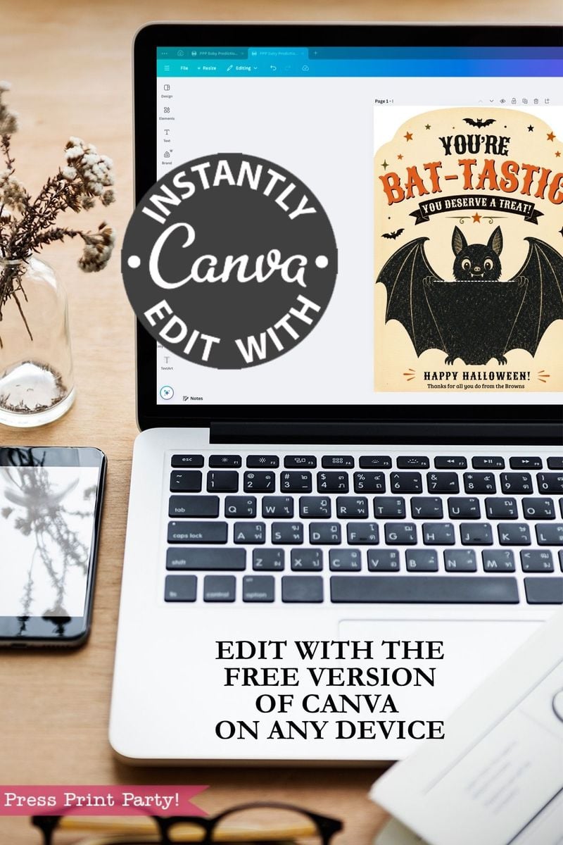 A laptop screen showcases a Canva design for the “7 Vintage Halloween Gift Card Holders,” highlighting a bat graphic that’s ideal for creating festive gift card holders. Overlay text states, “INSTANTLY EDIT WITH Canva” and “EDIT WITH THE FREE VERSION OF CANVA ON ANY DEVICE.” Nearby, you can see a phone, notebook, and plant.