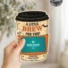 A hand holds one of the 7 Vintage Halloween Gift Card Holders, designed as an adorable coffee cup with the phrase “A Little Brew For You!” and a charming ghost illustration. This festive holder features orange accents and decorative stars, making it perfect for presenting a coffee shop gift card for Halloween.