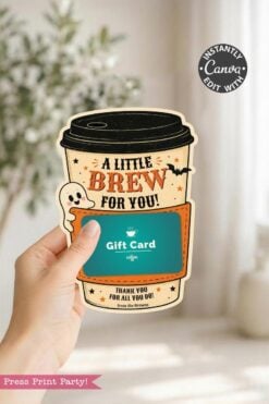 A hand holds one of the 7 Vintage Halloween Gift Card Holders, designed as an adorable coffee cup with the phrase “A Little Brew For You!” and a charming ghost illustration. This festive holder features orange accents and decorative stars, making it perfect for presenting a coffee shop gift card for Halloween.