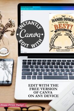A laptop on a desk displays a Canva design featuring the “7 Vintage Halloween Gift Card Holders,” perfect for creating your own Halloween card holders. Overlay text promotes editing with the free version of Canva. A plant, notebook, and glasses are arranged nearby.