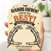 A hand holds one of the 7 Vintage Halloween Gift Card Holders, featuring skeleton hands and the message: “Hands Down! You’re the Best! You Deserve a Treat! Happy Halloween!” Decorative bats and festive colors make these holders a perfect choice for presenting gift cards this Halloween.