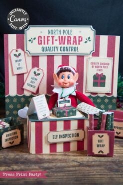 An elf doll sits at a festive “North Pole Gift-Wrap Quality Control” station decorated with striped accents, gift boxes, and inspection signs. The Christmas scene features red, green, and cream tones with a whimsical twist—a set of 6 Pink Coquette Halloween Ghost Round Labels peeks out playfully among the holiday trimmings.