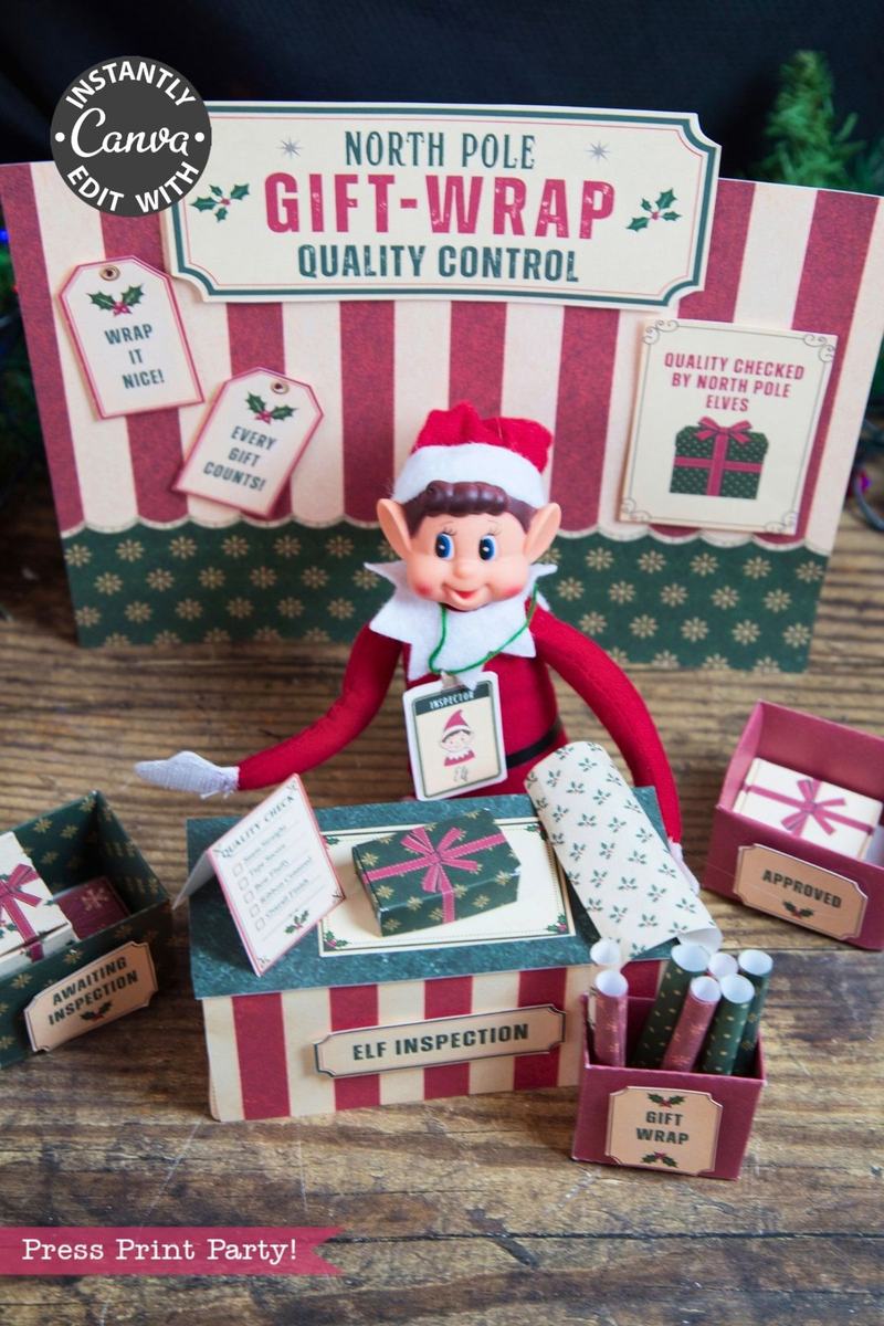 A festive elf doll sits at a “North Pole Gift-Wrap Quality Control” station, surrounded by wrapped presents, signs, and gift wrap rolls with a Christmas theme—each package adorned with 6 Pink Coquette Halloween Ghost Round Labels for an extra touch of whimsical holiday magic.