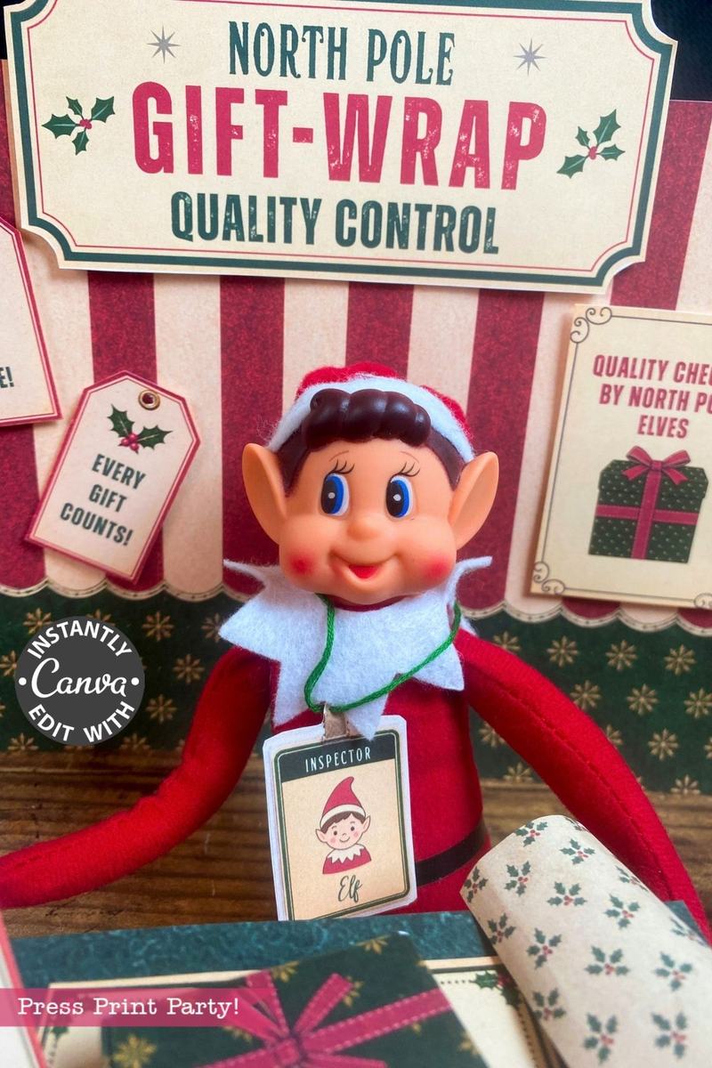 A festive elf doll with a tag reading “Inspector Elf” sits at a North Pole-themed gift-wrap quality control station, surrounded by holiday signs, wrapping paper rolls, and 6 Pink Coquette Halloween Ghost Round Labels that add a whimsical touch to the scene.