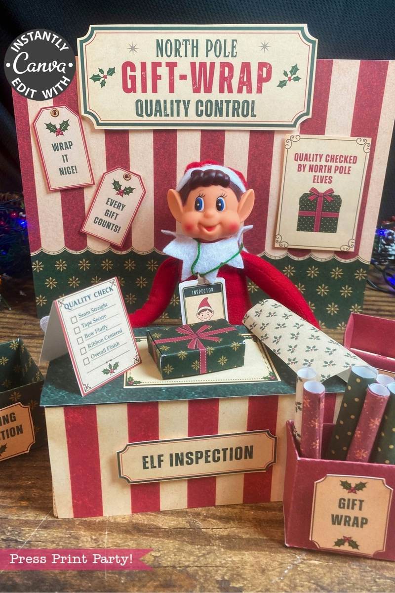 A Christmas elf doll sits at a festive “North Pole Gift-Wrap Quality Control” station surrounded by wrapping paper, boxes, and cheerful signs about gift wrapping quality on a striped red and beige background. Six Pink Coquette Halloween Ghost Round Labels add an unexpected, whimsical touch to the holiday scene.