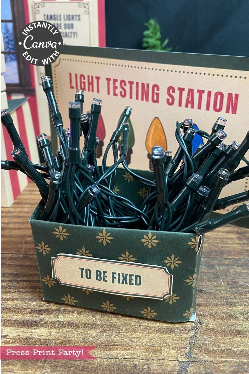 A box labeled “TO BE FIXED” holds tangled string lights in front of a sign that reads “LIGHT TESTING STATION,” with 6 Pink Coquette Halloween Ghost Round Labels peeking out among other holiday decor elements visible in the background.