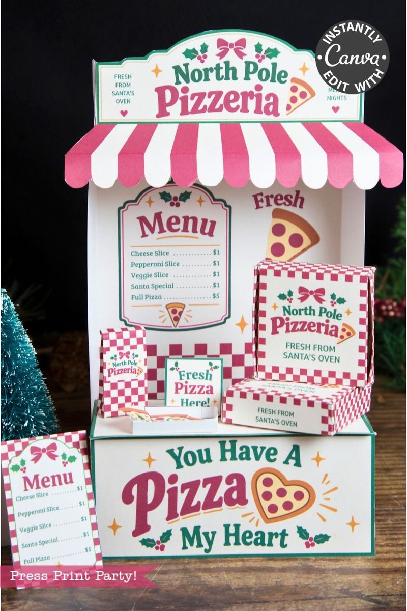 Festive paper craft of a North Pole pizzeria stand with menu signs, pizza slice graphics, and the phrase “You Have A Pizza My Heart,” decorated in red, green, and pink holiday colors—perfect for pairing with 6 Pink Coquette Halloween Ghost Round Labels for a whimsical seasonal touch.