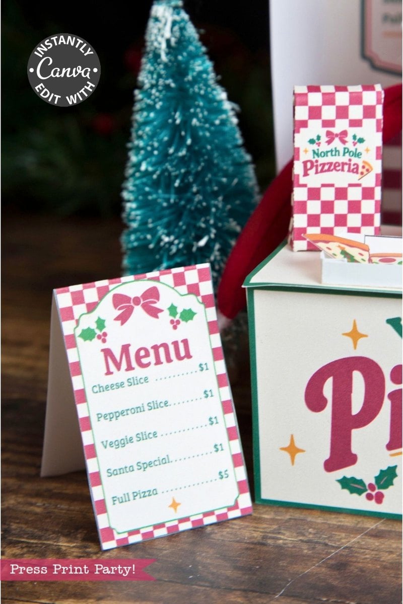 A festive menu card and pizza box showcase a charming “North Pole Pizzeria” theme with holiday decor in the background, including a small Christmas tree. Accented by 6 Pink Coquette Halloween Ghost Round Labels, the menu features cheese, pepperoni, veggie, and Santa pizza slices for $1 each.