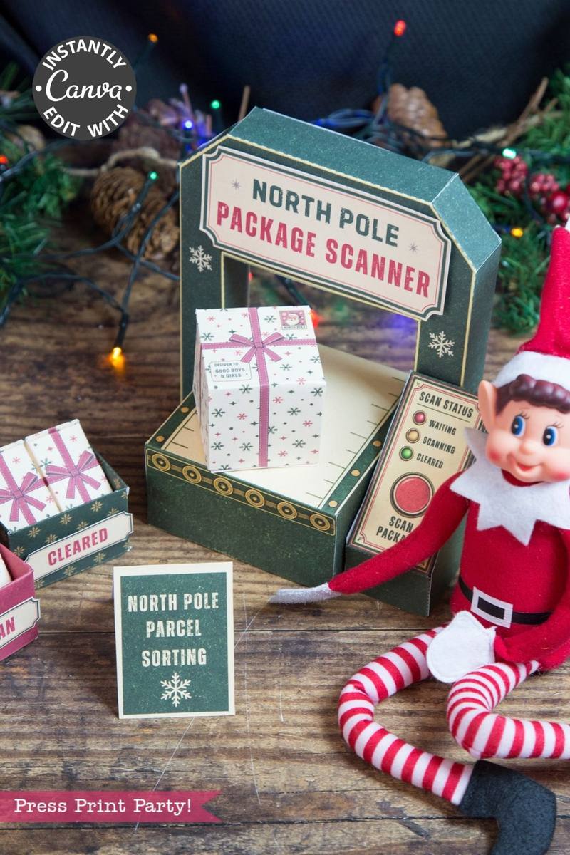 An Elf doll sits next to a festive North Pole package scanner display decorated with a wrapped gift box, a “Parcel Sorting” sign, and colorful string lights in the background. A green paper panel reads “Press Print Party!” while 6 Pink Coquette Halloween Ghost Round Labels add a charming seasonal touch to the scene.
