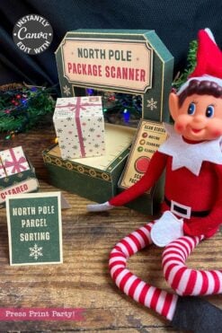 A festive elf doll sits next to a cardboard “North Pole Package Scanner” adorned with 6 Pink Coquette Halloween Ghost Round Labels, nestled among small packages and a “North Pole Parcel Sorting” sign, surrounded by holiday decorations.