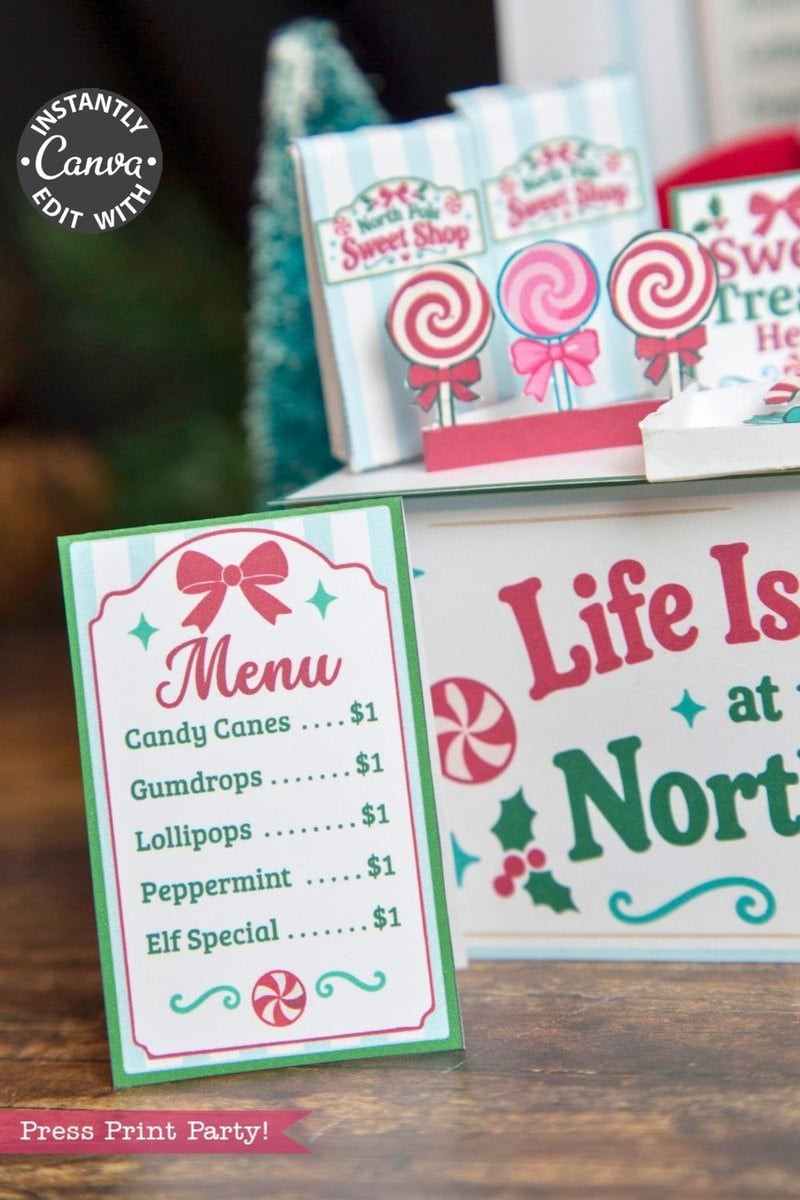 A festive candy shop menu sign, styled with 6 Pink Coquette Halloween Ghost Round Labels, lists Candy Canes, Gumdrops, Lollipops, Peppermint, and an Elf Special—each for $1—with colorful decorations and a cheerful holiday theme.