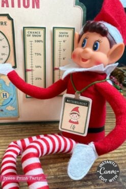 A plush elf doll wearing a “Meteorologist Elf” badge sits in front of a snow forecast chart, dressed in a red outfit with striped leggings and surrounded by the 6 Pink Coquette Halloween Ghost Round Labels. A circular “Instantly Canva Edit With” sticker appears on the photo.