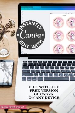 A laptop displays 6 Pink Coquette Halloween Ghost Round Labels sticker designs in Canva. A black circle reads “INSTANTLY EDIT WITH Canva.” Text below says, “Edit with the free version of Canva on any device.” A plant and phone are beside the laptop.