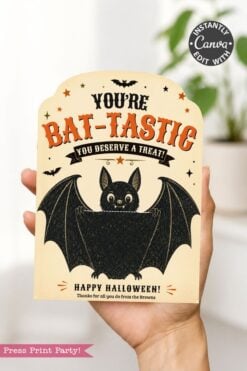 A hand holds a Halloween card featuring a smiling cartoon bat, stars, and bats with the message, “You’re BAT-TASTIC, you deserve a treat! Happy Halloween! Thanks for all you do from the Browns.” Perfect for slipping inside 7 Vintage Halloween Gift Card Holders to make your spooky surprise extra special.