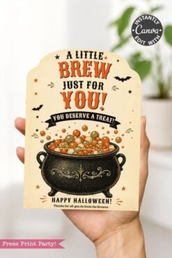 A hand holds one of the 7 Vintage Halloween Gift Card Holders, featuring a cauldron filled with colorful balls, bats, and stars. The card is perfect for holding Halloween gift cards and reads: βA little brew just for you! You deserve a treat! Happy Halloween!β.