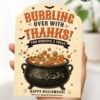 A hand holds one of the 7 Vintage Halloween Gift Card Holders, featuring a bubbling cauldron filled with colorful treats and the message, “Bubbling over with thanks! You deserve a treat! Happy Halloween!” Decorated with black bats and festive stars, this card is perfect for presenting a gift card on Halloween.
