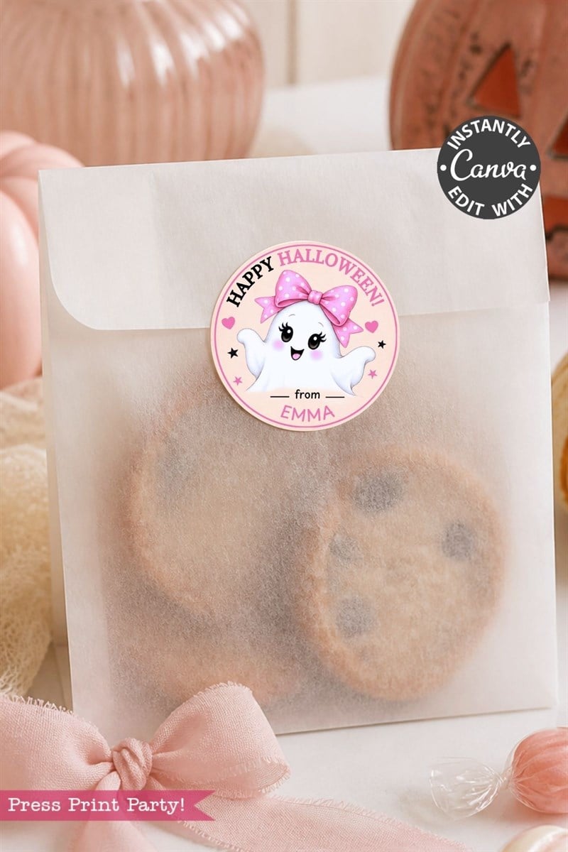 A translucent treat bag filled with chocolate chip cookies is sealed with one of the 6 Pink Coquette Halloween Ghost Round Labels—each featuring a cute ghost with a pink bow and the message “Happy Halloween from Emma.” The design, inspired by coquette style, includes pink bows and pumpkins in the background.