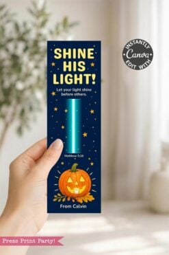 A hand holds a bookmark with a pumpkin, stars, and the text “SHINE HIS LIGHT!” plus a Bible verse; it reads “From Calvin” at the bottom.