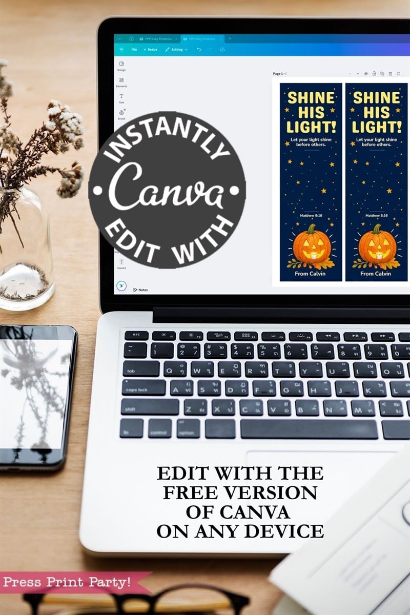 A laptop displays a Canva design for bookmarks with pumpkins and stars. Text on image promotes Canva editing, stating, “Edit with the free version of Canva on any device.” Nearby is a phone and a vase.