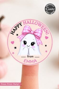 Add a sweet touch to your Halloween with these 6 Pink Coquette Halloween Ghost Round Labels, featuring a round sticker of a cute ghost wearing a pink bow, blushing and smiling, with the message “Happy Halloween! from Emma” in black and pink letters. Shown held on a fingertip—perfect for your festive labeling needs.