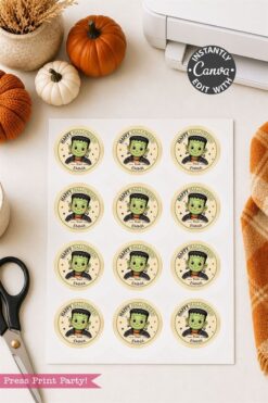 A sheet of round Halloween stickers featuring a cute green monster, with “Happy Halloween” and a customizable name. Surrounded by pumpkins, scissors, a printer, and cozy autumn decor.