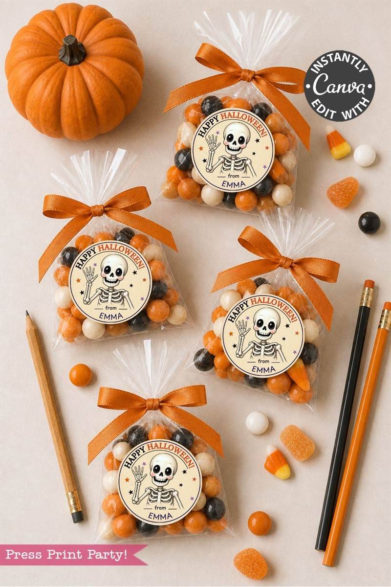 Four clear treat bags with Halloween candy and skeleton labels, tied with orange ribbon, are arranged on a table with candy corn, pencils, a pencil sharpener, and a small pumpkin.