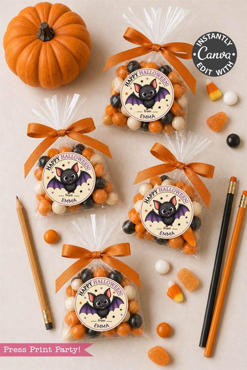 Four Halloween treat bags with bat-themed tags, orange bows, and assorted candies are arranged on a table alongside a small pumpkin, pencils, colored markers, and candy corn. Pink Coquette Ghost Treat Bag Halloween Stickers add a playful touch to the festive scene.