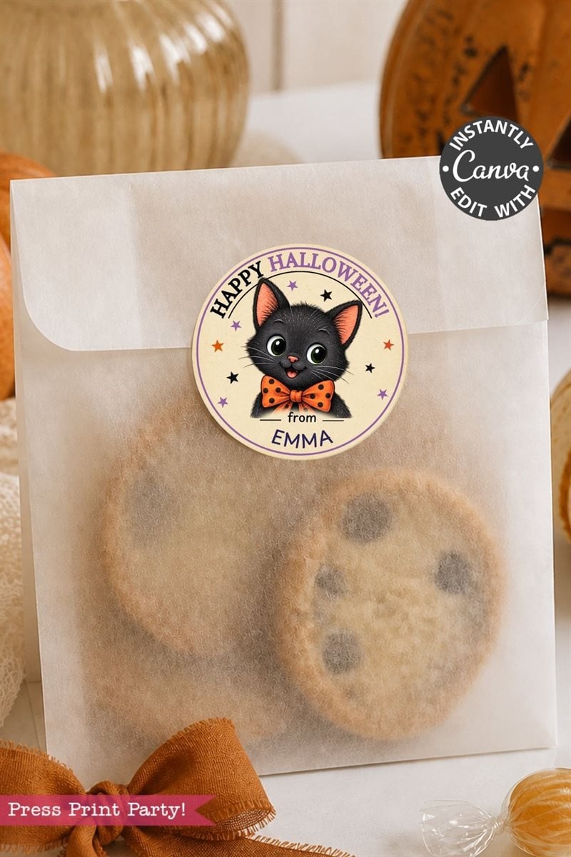 A white treat bag filled with cookies is sealed with a round sticker showcasing a charming black cat in an orange bow tie and the message “Happy Halloween from EMMA.” Decorated with Pink Coquette Ghost Treat Bag Halloween Stickers, the bag stands out among festive decorations in the background.