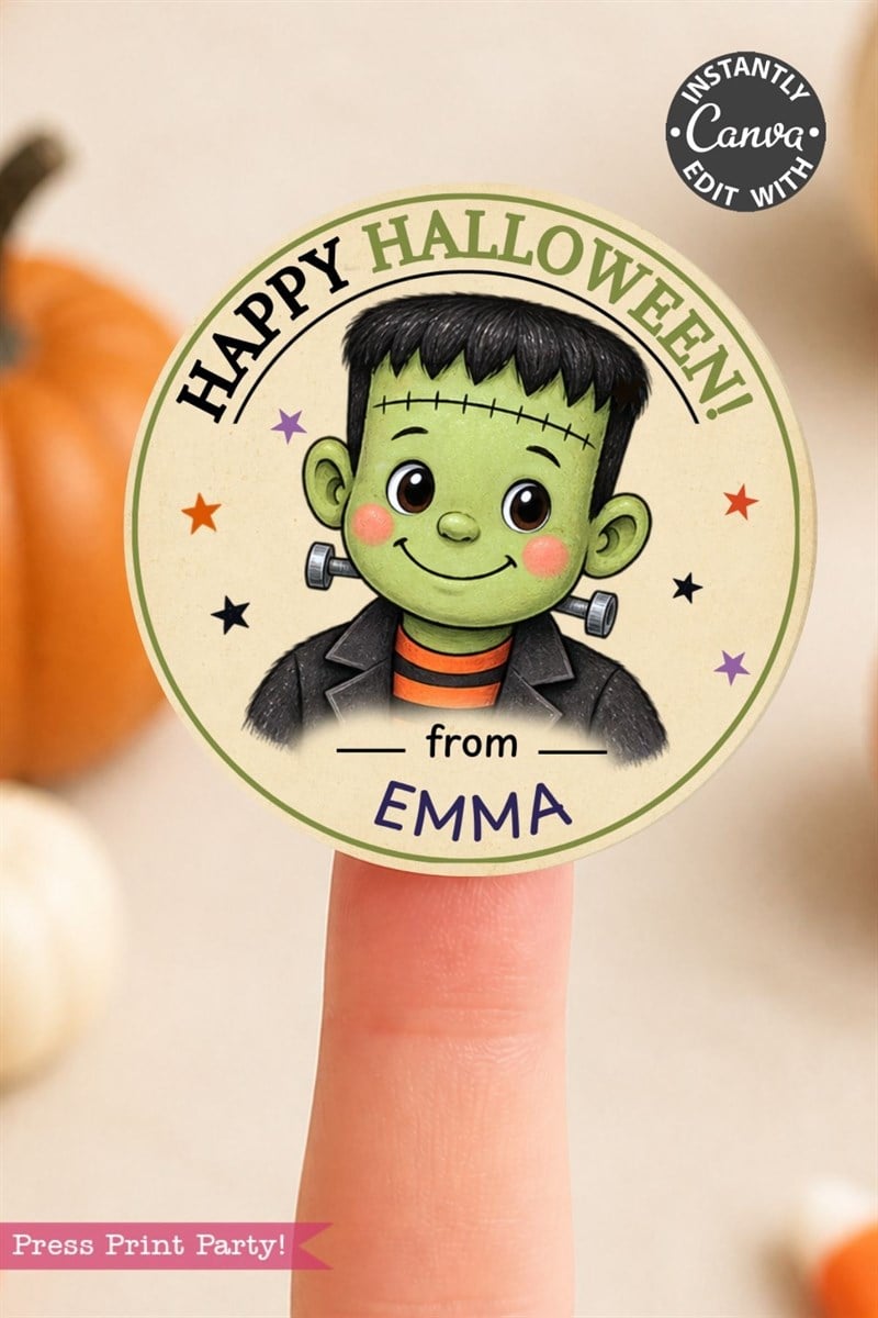 A Pink Coquette Ghost Treat Bag Halloween Sticker featuring a cute cartoon Frankenstein and the text “Happy Halloween! from EMMA” is held on a fingertip, adding an adorable touch to your celebrations with blurred pumpkins in the background.