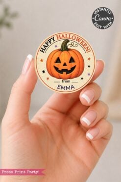 A hand with a French manicure holds a round sticker featuring a carved pumpkin, the message “Happy Halloween from Emma,” and decorative stars—perfect for customizing your own Pink Coquette Ghost Treat Bag Halloween Stickers. A “Canva” edit label appears in the top right corner.
