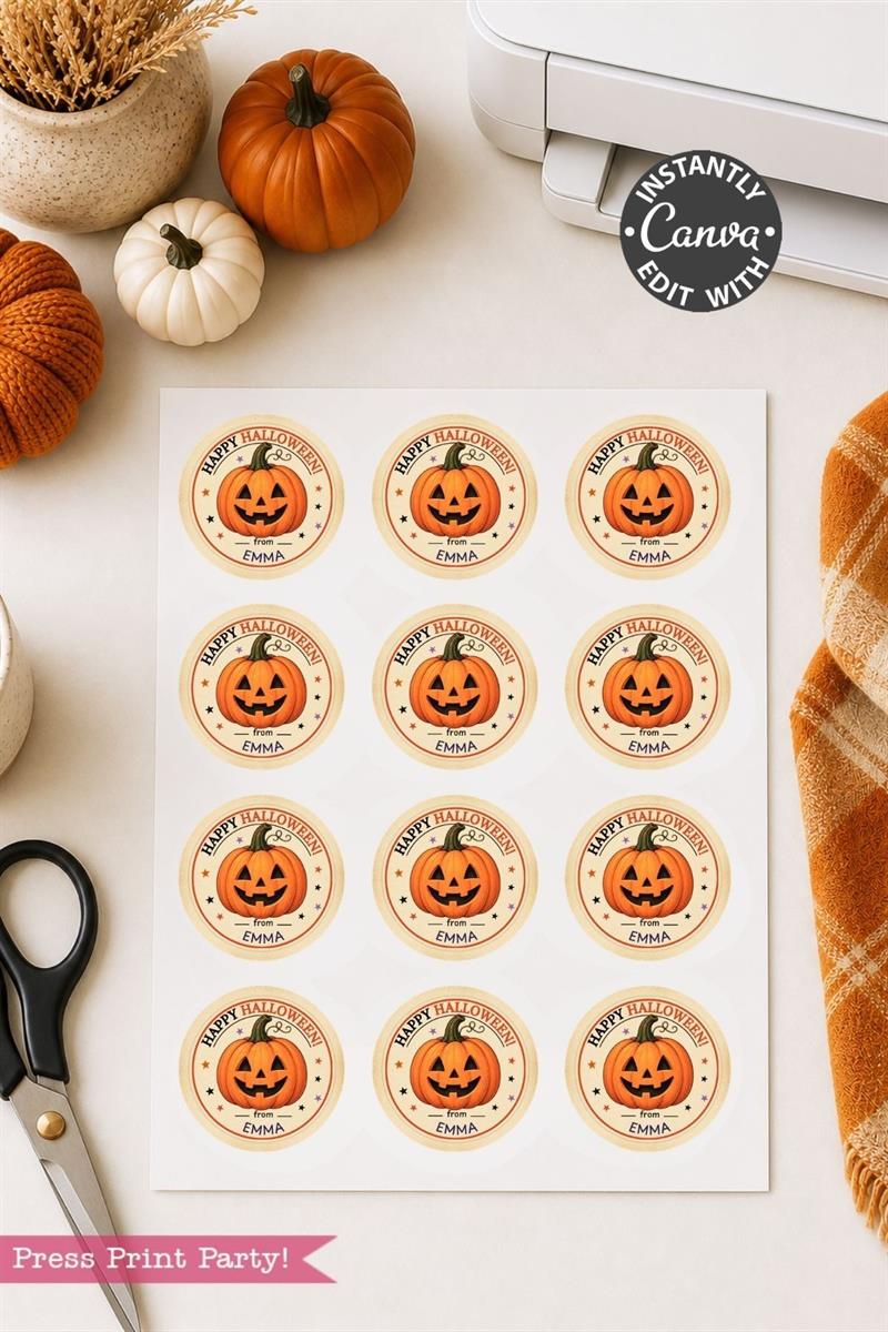 A sheet of Pink Coquette Ghost Treat Bag Halloween Stickers, featuring round, pink stickers with smiling jack-o’-lanterns and “Happy Halloween” messages, sits on a table alongside scissors, pumpkins, a plaid cloth, and a printer. The stickers are customizable in Canva.