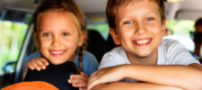 2 kids laughin in car with games to play in the car
